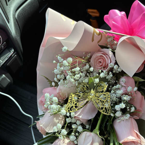 Pink rose bouquet with baby's breath and a gold butterfly decoration