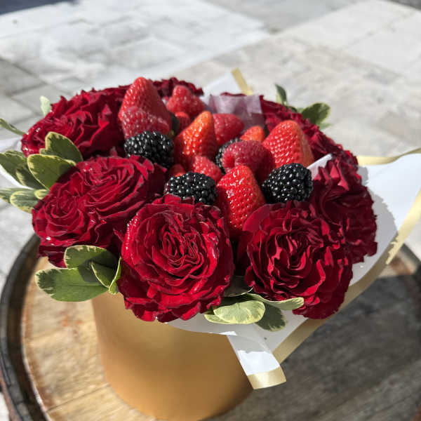 Red rose bouquet with strawberries and blackberries in a gold box