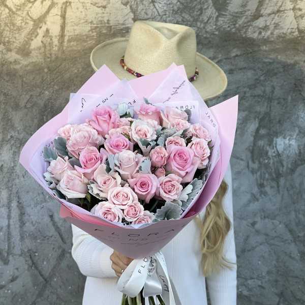 Large bouquet of pink roses wrapped in pastel paper