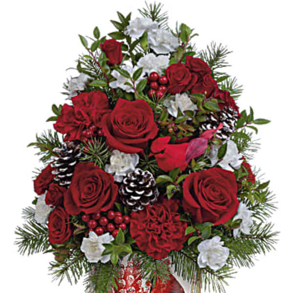 Red roses and white flowers in a festive holiday vase