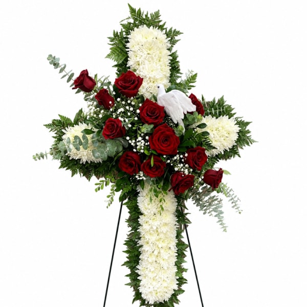 Standing floral cross with red roses and white chrysanthemums on an easel