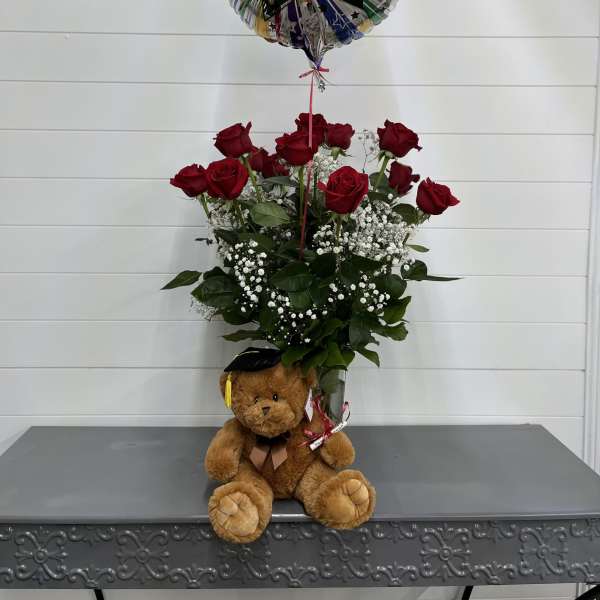 Red rose arrangement with a graduation balloon and teddy bear
