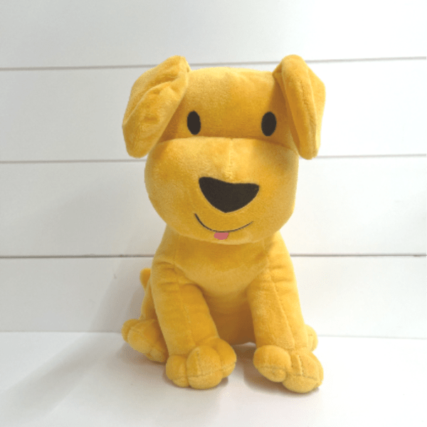 Yellow plush dog toy sitting upright
