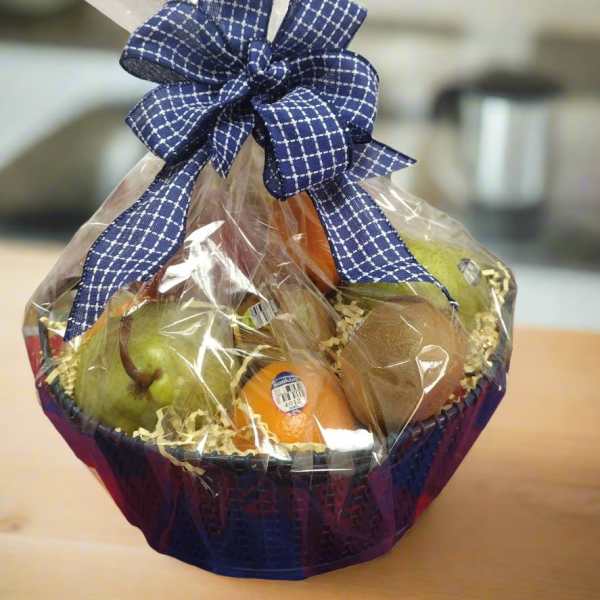 Fruit basket wrapped in clear cellophane with a blue ribbon