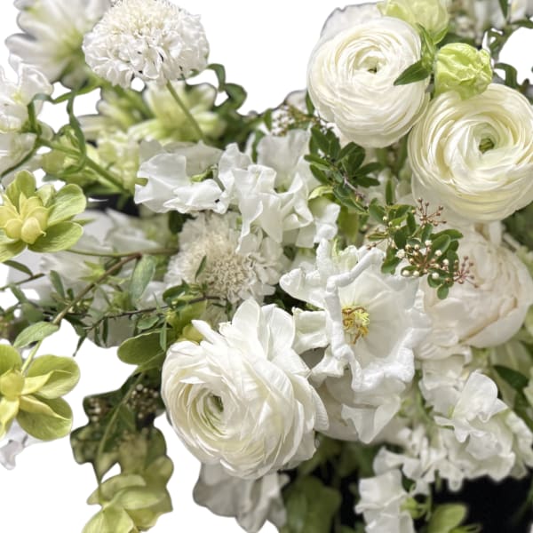 White floral bouquet with green accents and layered blooms