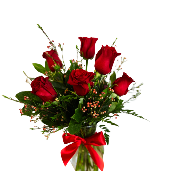 Red roses in a glass vase with a red ribbon