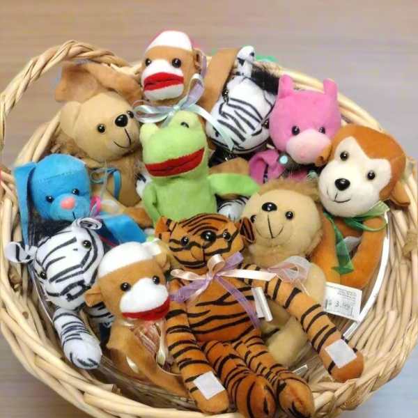 Basket of small animal plush toys in assorted colors