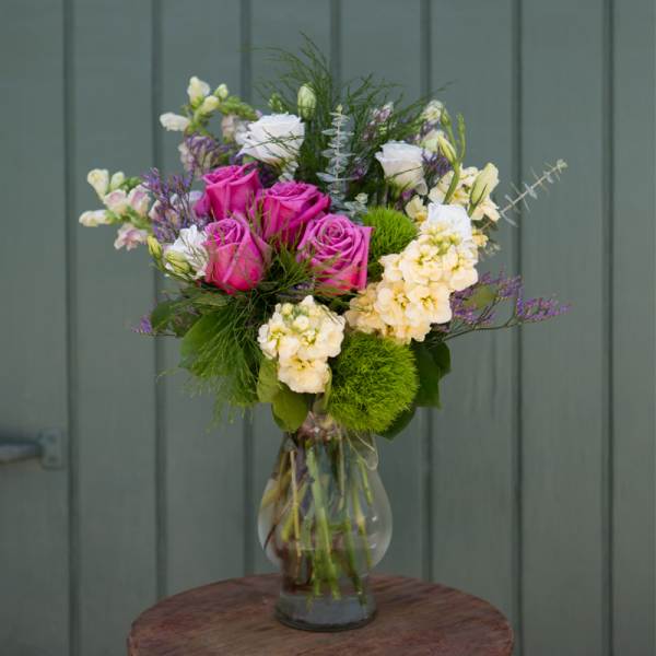 Bouquet of pink and white flowers in a clear glass vase