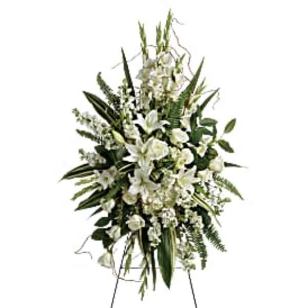Tall white floral standing spray on a metal easel