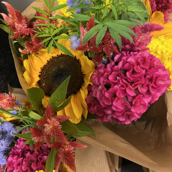 Bright mixed bouquet with sunflowers and pink cockscomb flowers