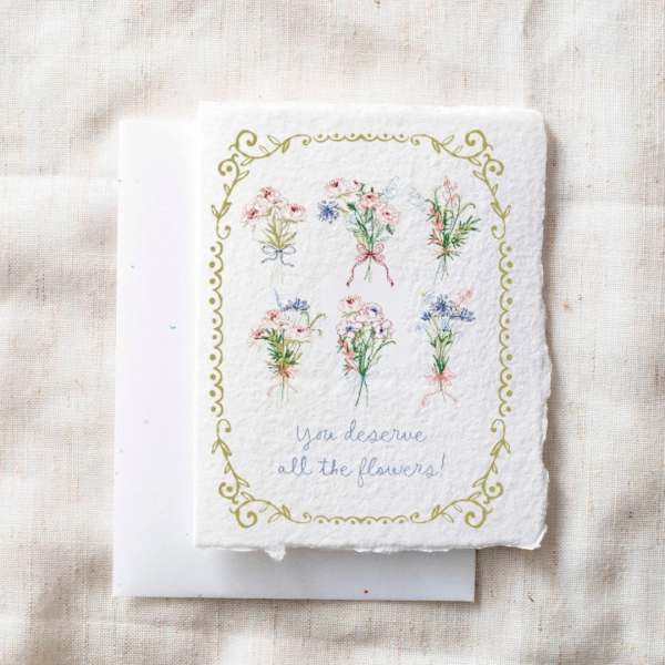 Decorative card with small illustrated flower bouquets and the words "you deserve all the flowers!"