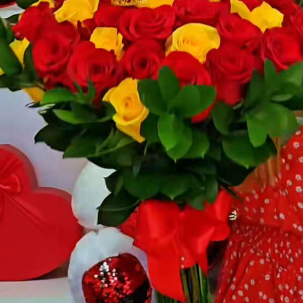 Bouquet of red and yellow roses with a gold crown topper