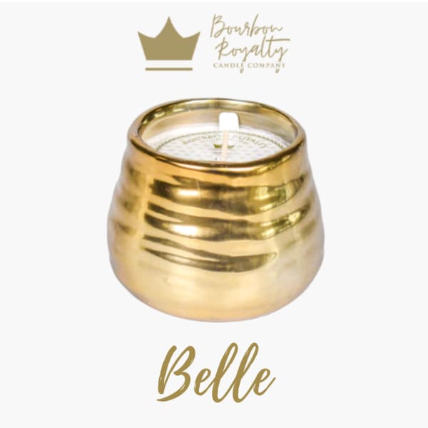 Gold candle in a rounded metallic holder with a white wick