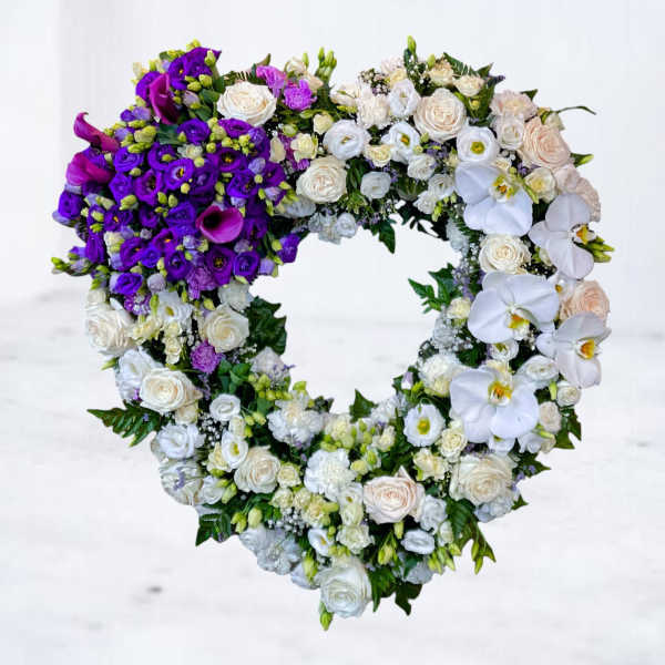 Heart-shaped floral wreath with purple and white flowers
