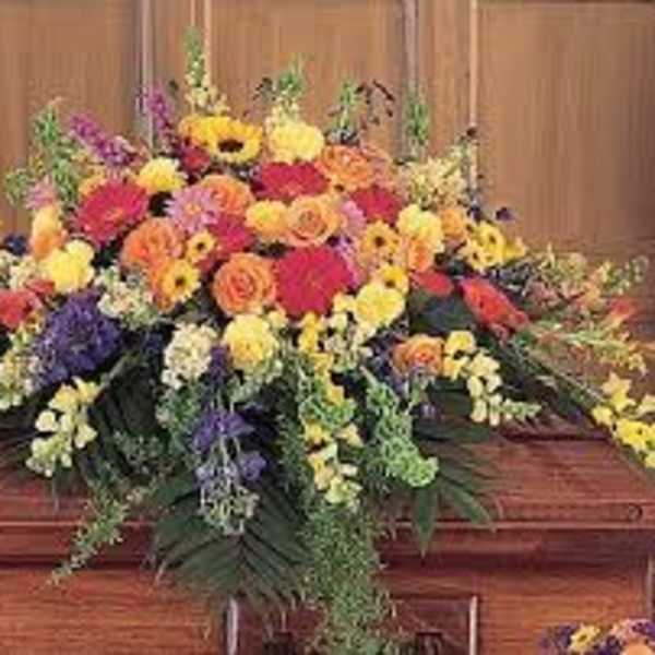 Large colorful floral casket spray with mixed blooms