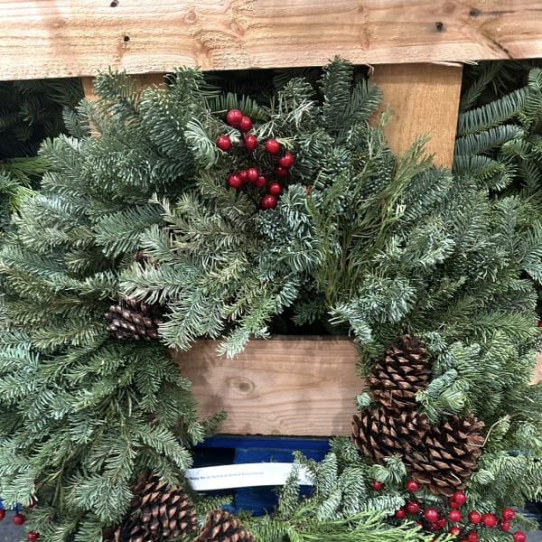 Evergreen holiday wreath with pinecones and red berries
