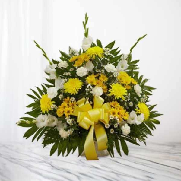 Yellow and white floral arrangement with a yellow ribbon