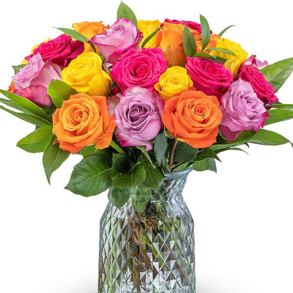 Mixed roses in bright pink, yellow, orange, and lavender in a glass vase