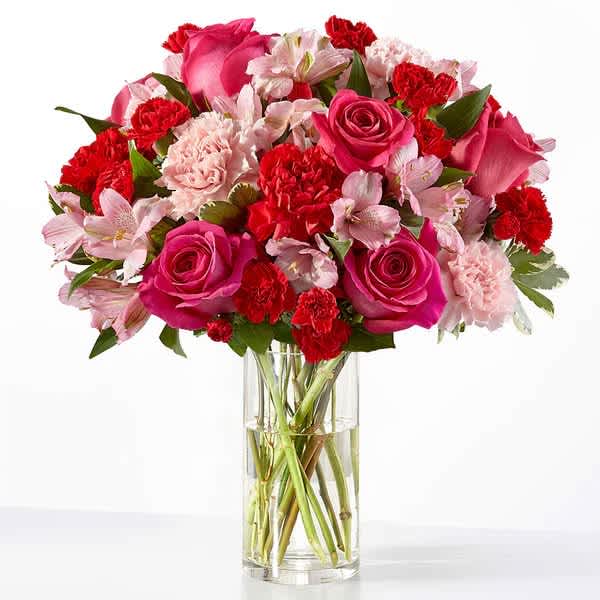 Pink and red mixed bouquet in a clear glass vase