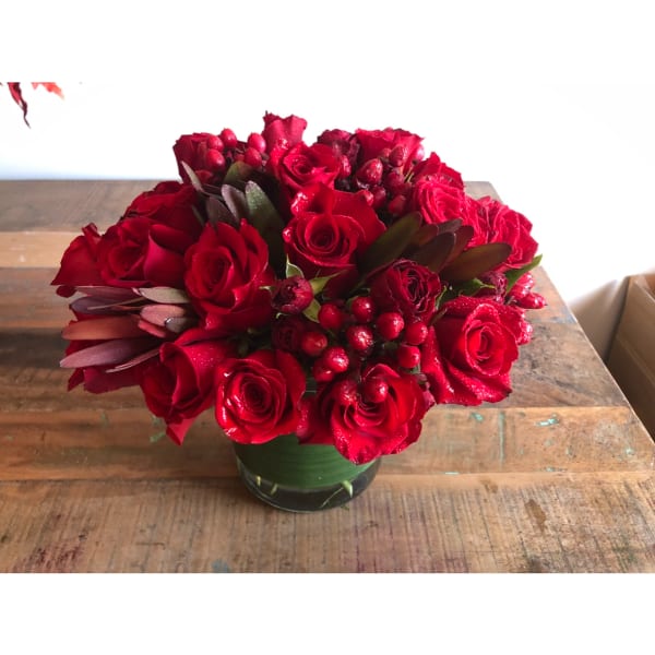 Red rose arrangement in a glass vase