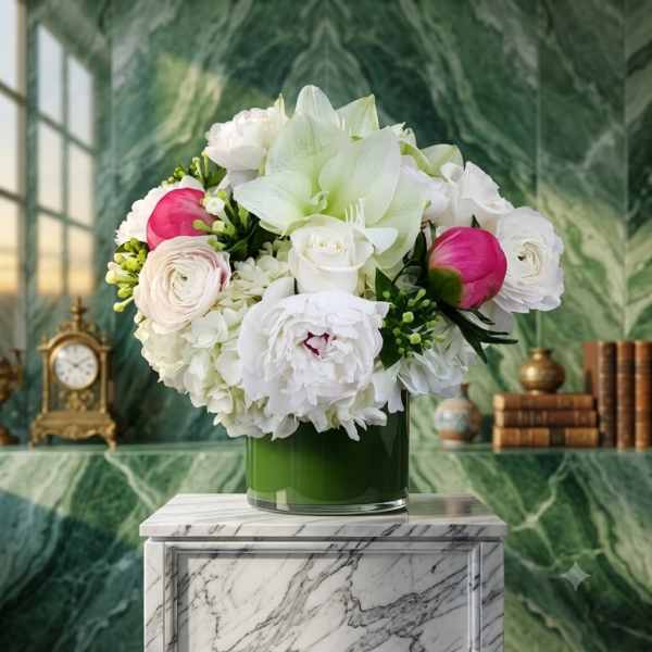 White and pink floral arrangement in a green glass vase