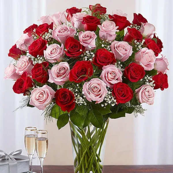 Bouquet of red and pink roses in a clear glass vase