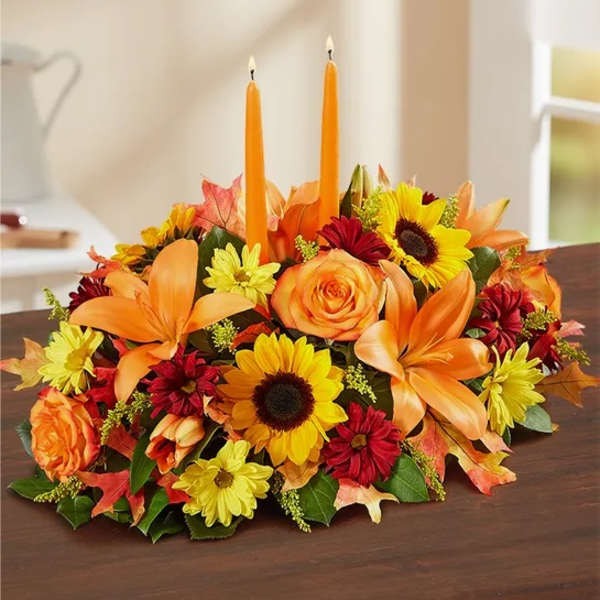 Autumn floral centerpiece with two orange candles