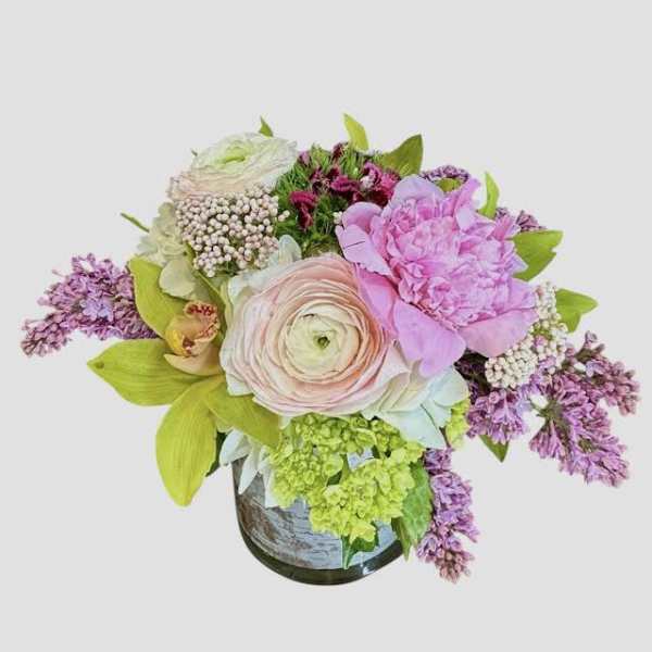 Pastel floral arrangement in a vase with pink and lavender blooms