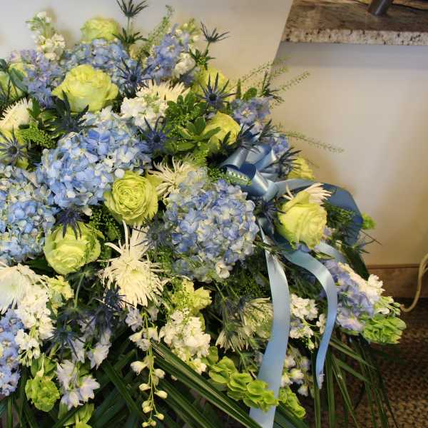 Large blue and white floral spray with ribbon