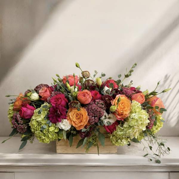 Mixed bouquet of roses and hydrangeas in a wooden box