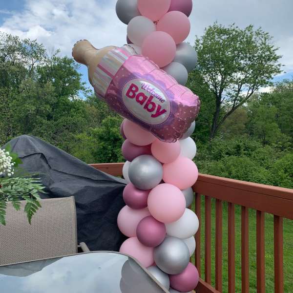 Pink and silver balloon column with a baby bottle balloon