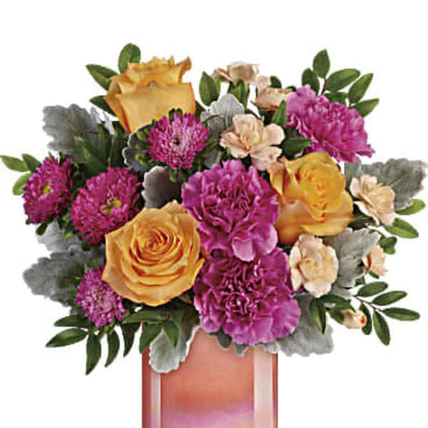 Bouquet of yellow roses and purple carnations in a glass vase