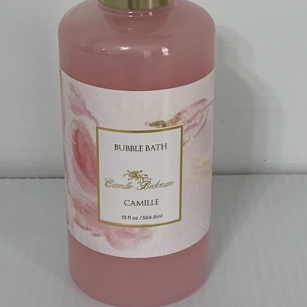 Pink bubble bath bottle with a gold cap and floral label