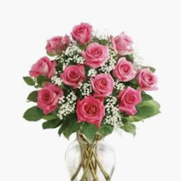 Pink roses arranged in a clear glass vase