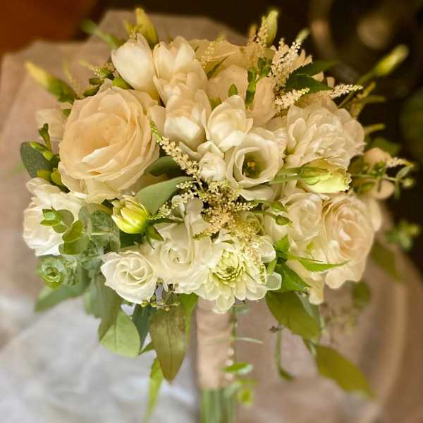 Cream and white bridal bouquet with roses and small white blooms