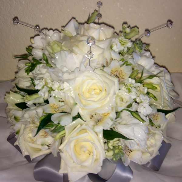 White rose bouquet with small white flowers and a silver ribbon