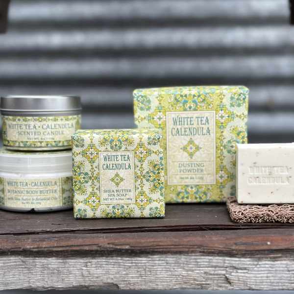 Assorted white tea calendula bath and body products in decorative packaging