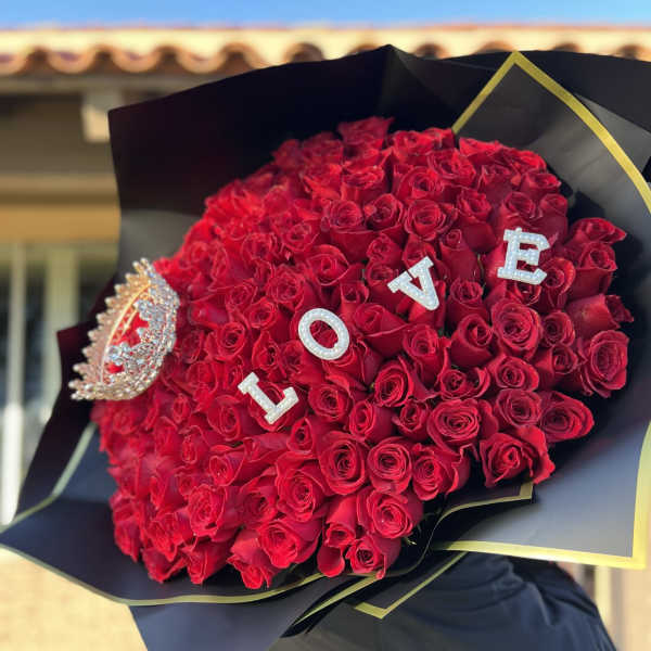 Large bouquet of red roses with LOVE letters and a jeweled brooch