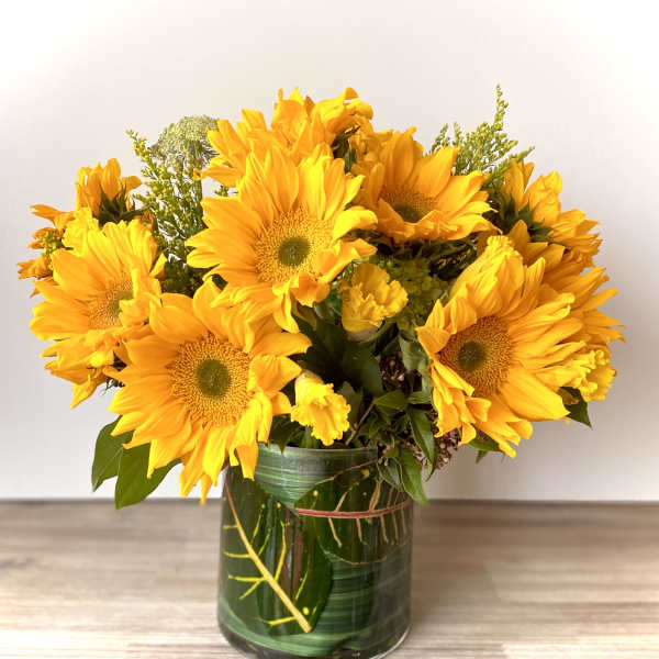 Bouquet of yellow sunflowers in a glass vase