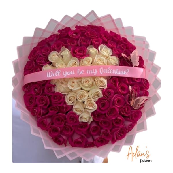 Heart-shaped bouquet of pink and white roses with a Valentine ribbon