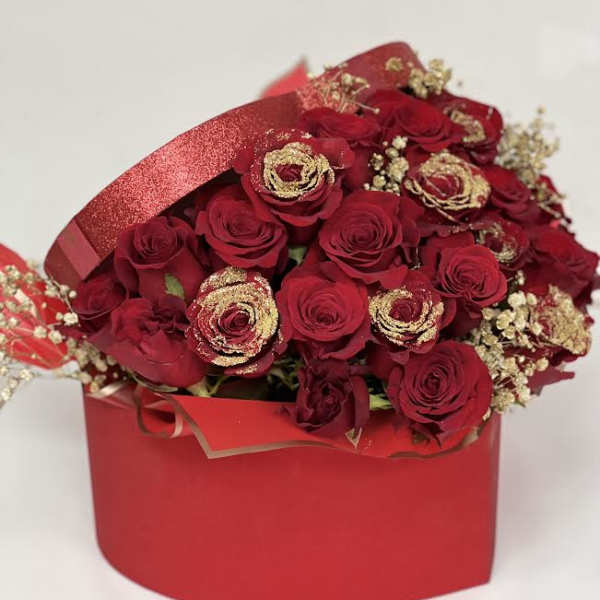 Red rose bouquet in a red gift box with gold accents