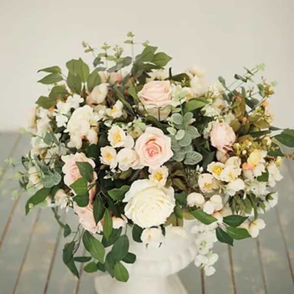 Large bouquet of pale pink and white roses with mixed white blooms