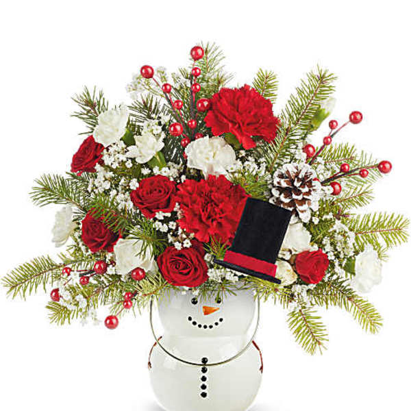Holiday bouquet in a snowman vase with red and white flowers