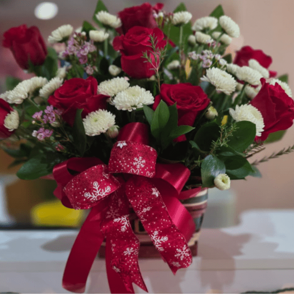 Bouquet of red roses and white button flowers with a red ribbon bow