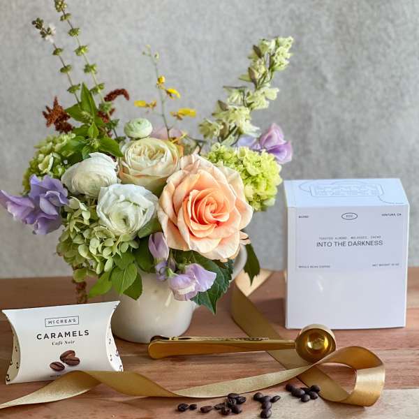 Mixed bouquet in a white vase with coffee and caramel gift items