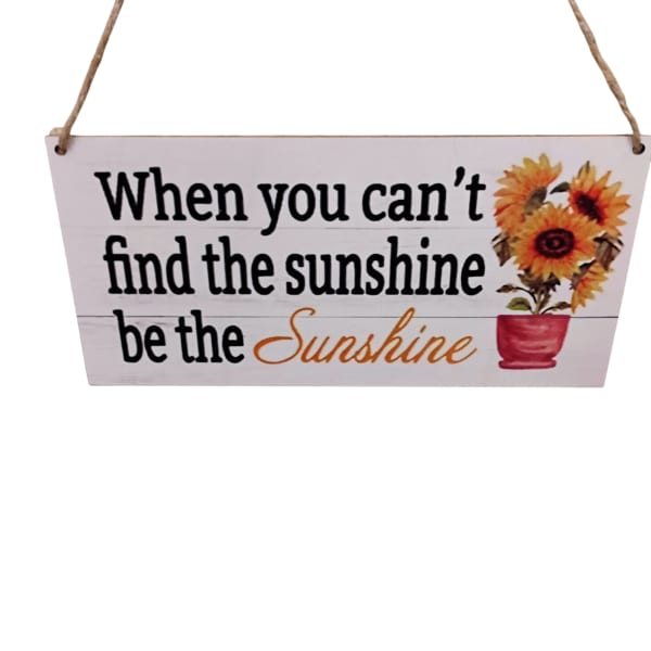Hanging wooden sign with sunflowers and the phrase "be the Sunshine"