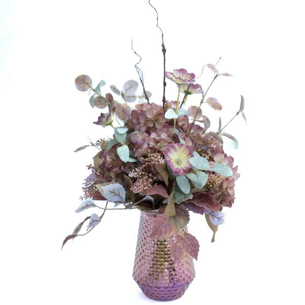 Pink and lavender floral arrangement in a textured vase