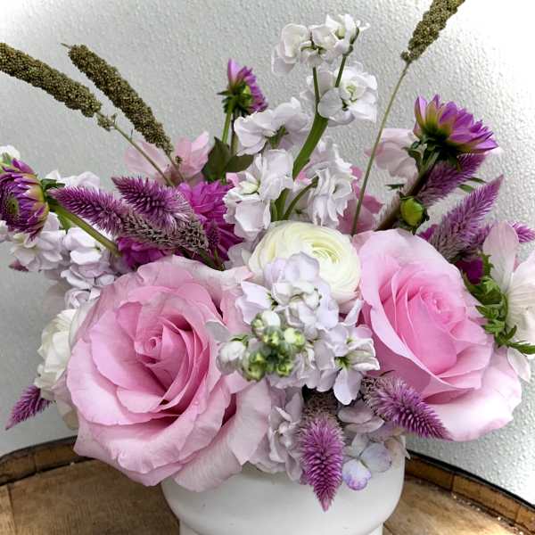 Pink and white floral arrangement in a white vase