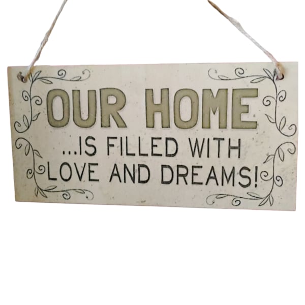 Hanging wooden sign reading "OUR HOME IS FILLED WITH LOVE AND DREAMS!"