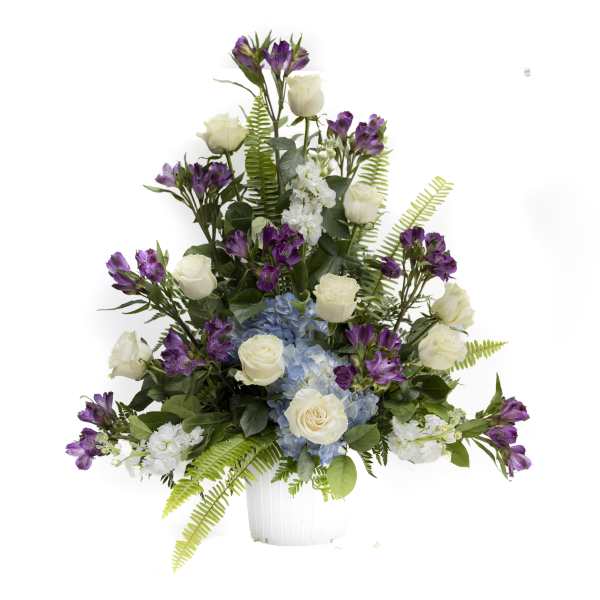White roses, blue hydrangea, and purple alstroemeria in a white vase